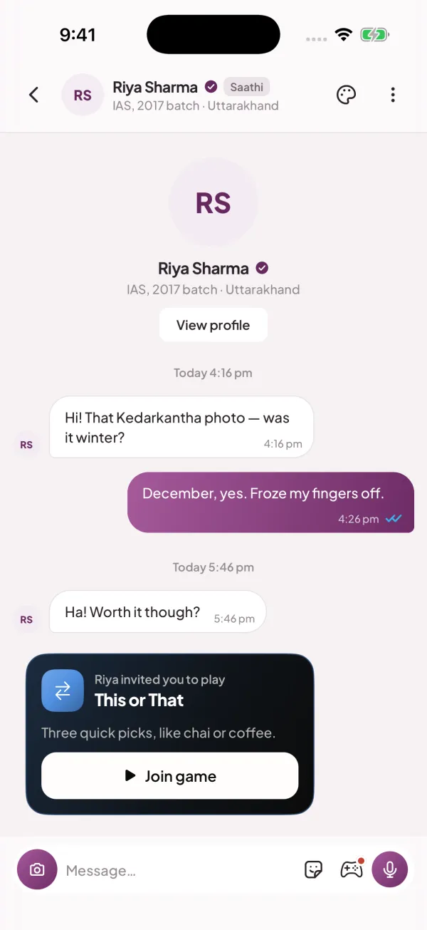 Officer Saathi app: a one-to-one sample chat with Riya Sharma, a verified IAS officer of the 2017 batch, about a winter trek to Kedarkantha, with her This or That game invite card and the message bar with photo, sticker, games and voice-note buttons.